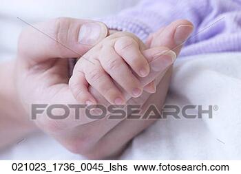 adult-hand-holding_~021023_1736_0045_lshs.jpg